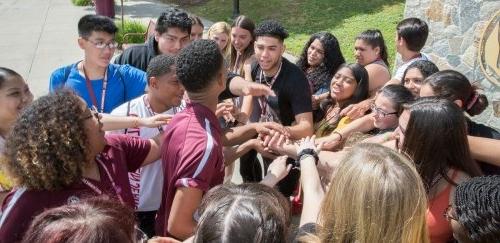 Students in a huddle during orientation